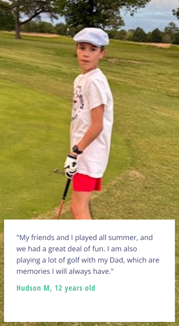 A youth golfer stands on a golf course, club in hand